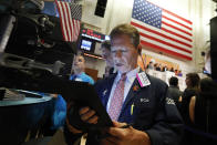 Trader Robert Charmak works on the floor of the New York Stock Exchange, Thursday, July 18, 2019. U.S. stocks moved lower in early trading on Wall Street Thursday after Netflix reported a slump in new subscribers and dragged down communications companies. (AP Photo/Richard Drew)