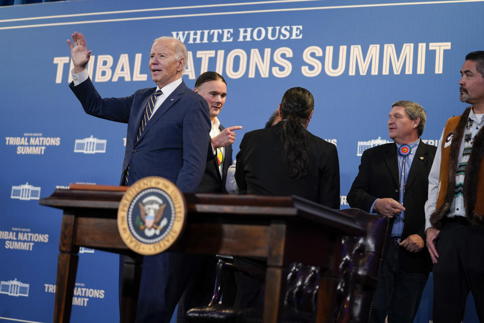President Joe Biden waves after signing an executive order during the White House Tribal Nations Summit at the Department of the Interior, Wednesday, Dec. 6, 2023, in Washington. (AP Photo/Evan Vucci)