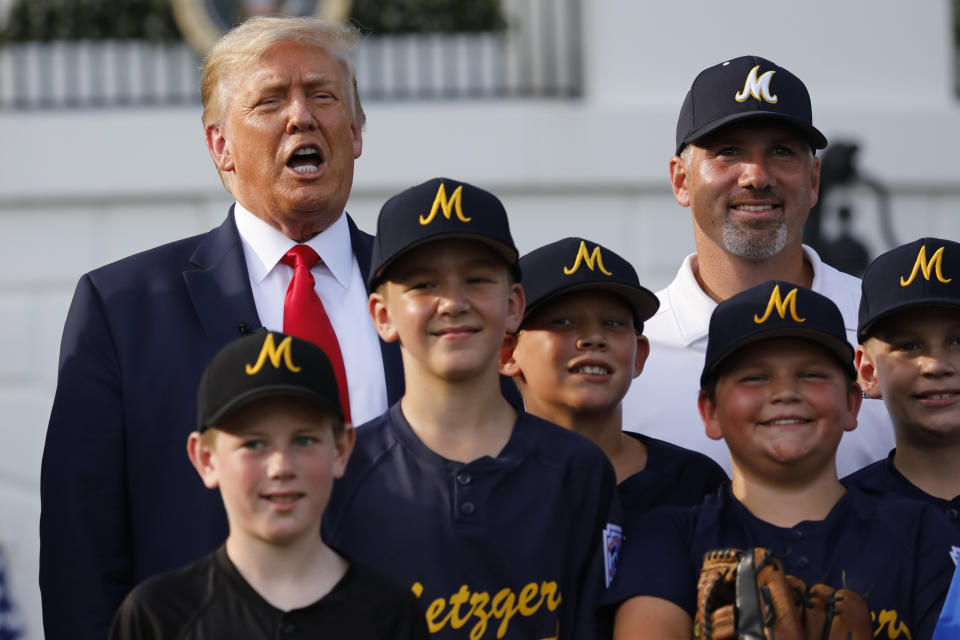 President Trump poses for a photograph with youth baseball players on the South Lawn of the White House in Washington, D.C., on Thursday. (Yuri Gripas/Abaca/Bloomberg via Getty Images)