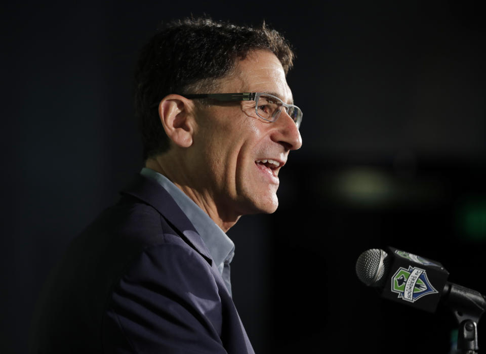 Seattle Sounders majority owner Adrian Hanauer talks to reporters, Tuesday, Aug. 13, 2019, in Seattle. Hanauer said Tuesday that the MLS soccer team is adding Seattle Seahawks NFL football quarterback Russell Wilson and his wife Ciara, hip-hop artist Macklemore, and Microsoft CEO Satya Nadella to the MLS club's ownership group, along with other investors. Hollywood producer Joe Roth, who helped bring the MLS to Seattle, is leaving the franchise. (AP Photo/Ted S. Warren)