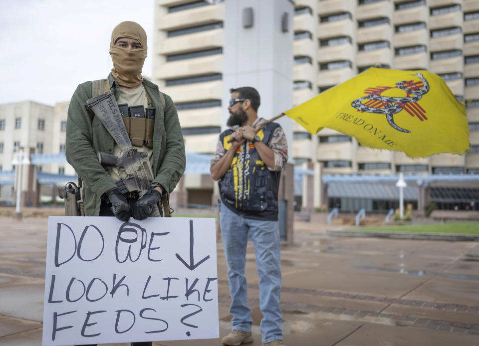 Individuals displays open carry firearm at a Second Amendment Protest in response to Gov. Michelle Lujan Grisham's recent public health order suspending the conceal and open carry of guns in and around Albuquerque for 30-days, Tuesday, Sept. 12, 2023, in Albuquerque, N.M. (AP Photo/Roberto E. Rosales)