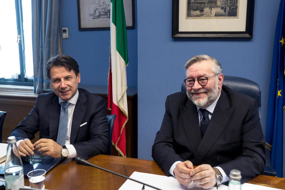 Italian Premier Giuseppe Conte, left, sits next to COPASIR (Italian parliamentary intelligence committee) head Raffaele Volpi before testifying behind closed doors to the committee about a meeting between United States Attorney General William Barr and Italian intelligence, in Rome, Wednesday, Oct. 23, 2019. Media reports have indicated that Conte authorized the contacts -- one in August and one in September -- in violation of protocol. (Angelo Carconi/ANSA via AP)