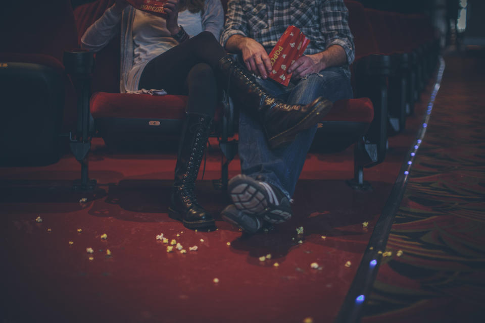 two people watching a movie in a movie theater