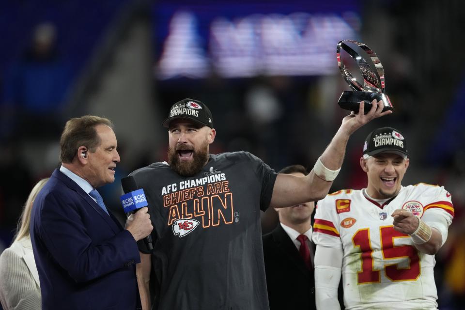 Kansas City Chiefs tight end Travis Kelce (87) holds a trophy after the AFC Championship NFL football game against the Baltimore Ravens, Sunday, Jan. 28, 2024, in Baltimore. Kansas City Chiefs quarterback Patrick Mahomes (15) stands at right. The Chiefs won 17-10. (AP Photo/Nick Wass)