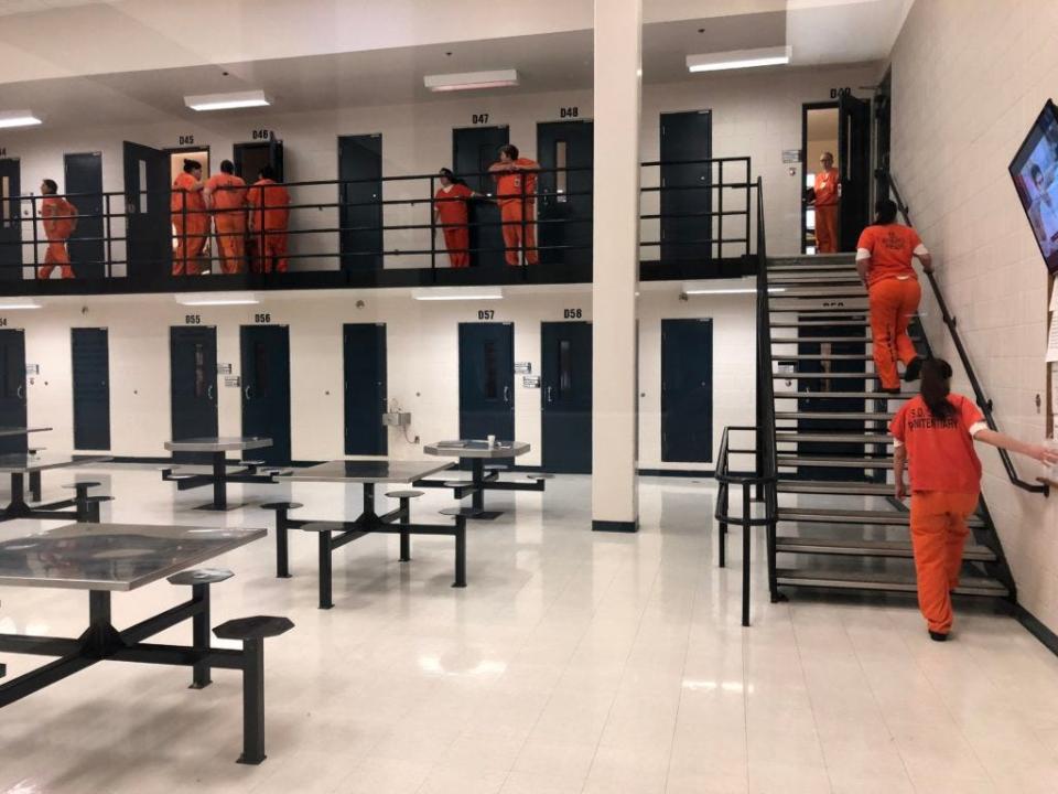 Women dressed in orange shirts file back into the medium-security housing unit within the South Dakota Women's Prison. The state has the fourth-highest rate of incarceration of women in the nation.