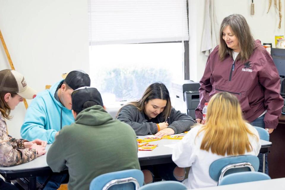 Gladys Wireman, a teacher at the David School in David, Ky., helps students with an assignment on Thursday, Feb. 8, 2024. Located in Floyd County, the school was founded in the early 1970s as an alternative for students at risk of dropping out of public schools.