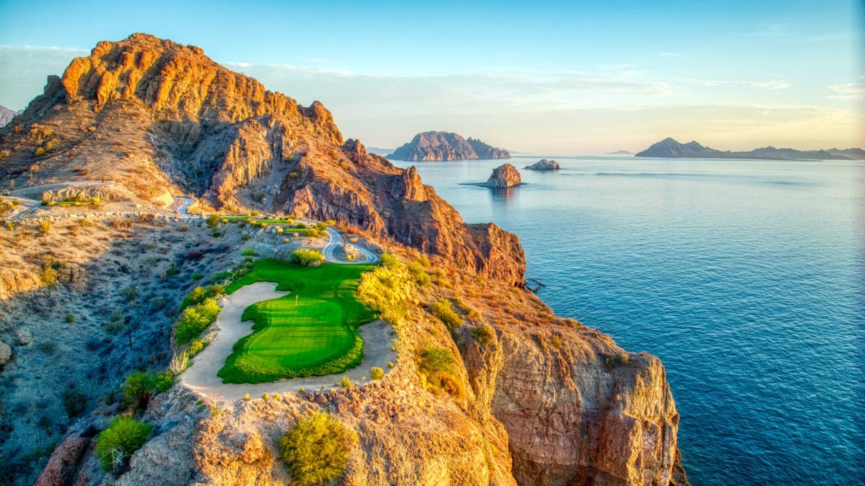  The Villa del Palmar at the Islands of Loreto golf course with the blue ocean and rock formations behind it. 