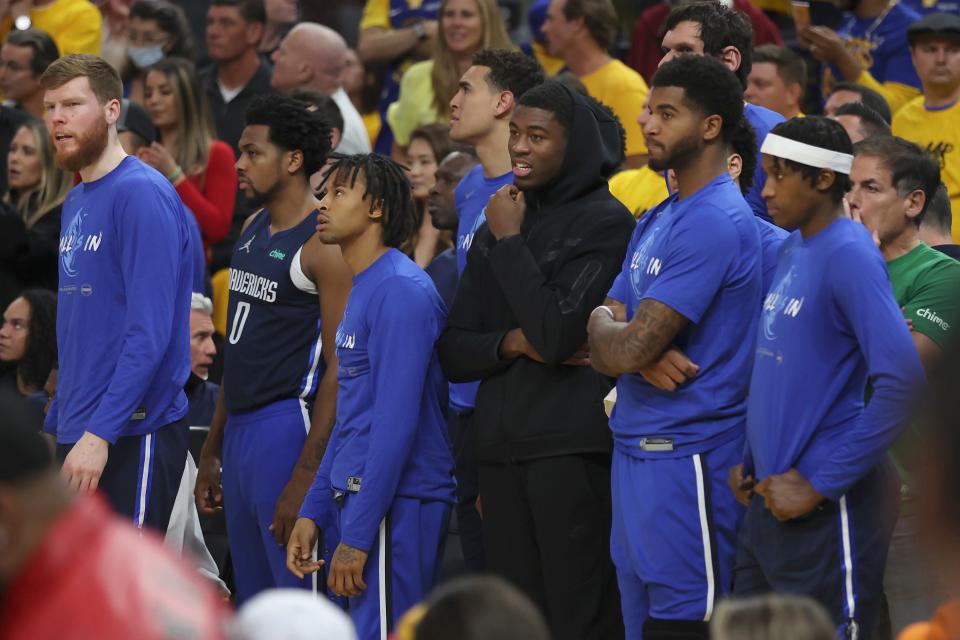 Mavericks players watch from the bench area during the second half of Game 2 of the Western Conference finals against Golden State on Friday.