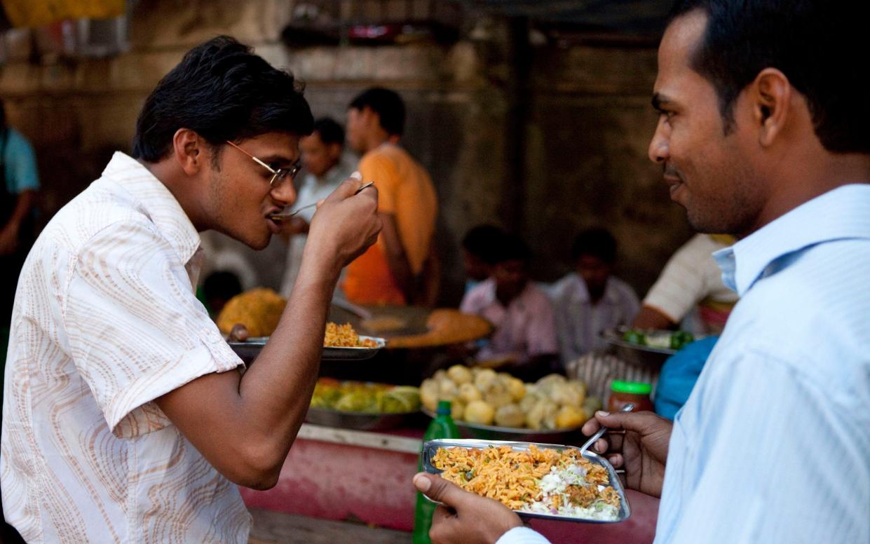 Food being eaten from a street vendor in Mumbai - Heathcliff O'Malley