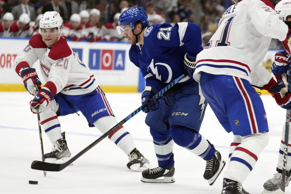 Tampa Bay Lightning center Brayden Point (21) gets around Montreal Canadiens left wing Juraj Slafkovsky (20) on his way to a goal during the second period of an NHL hockey game Wednesday, Dec. 28, 2022, in Tampa, Fla. (AP Photo/Chris O'Meara)