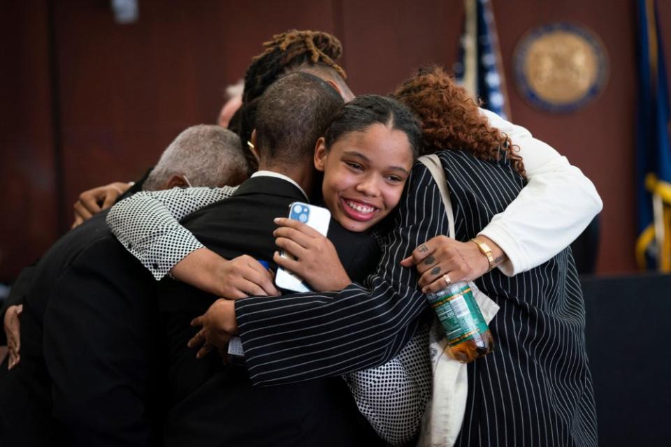 Aretha Franklin's granddaughter Grace Franklin, 17, smiles while embracing her family members after the jury decided in favor of a 2014 document during a trial over her grandmother's wills at Oakland County Probate Court in Pontiac, Mich., on July 11.<span class="copyright">Sarahbeth Maney—Detroit Free Press/AP</span>