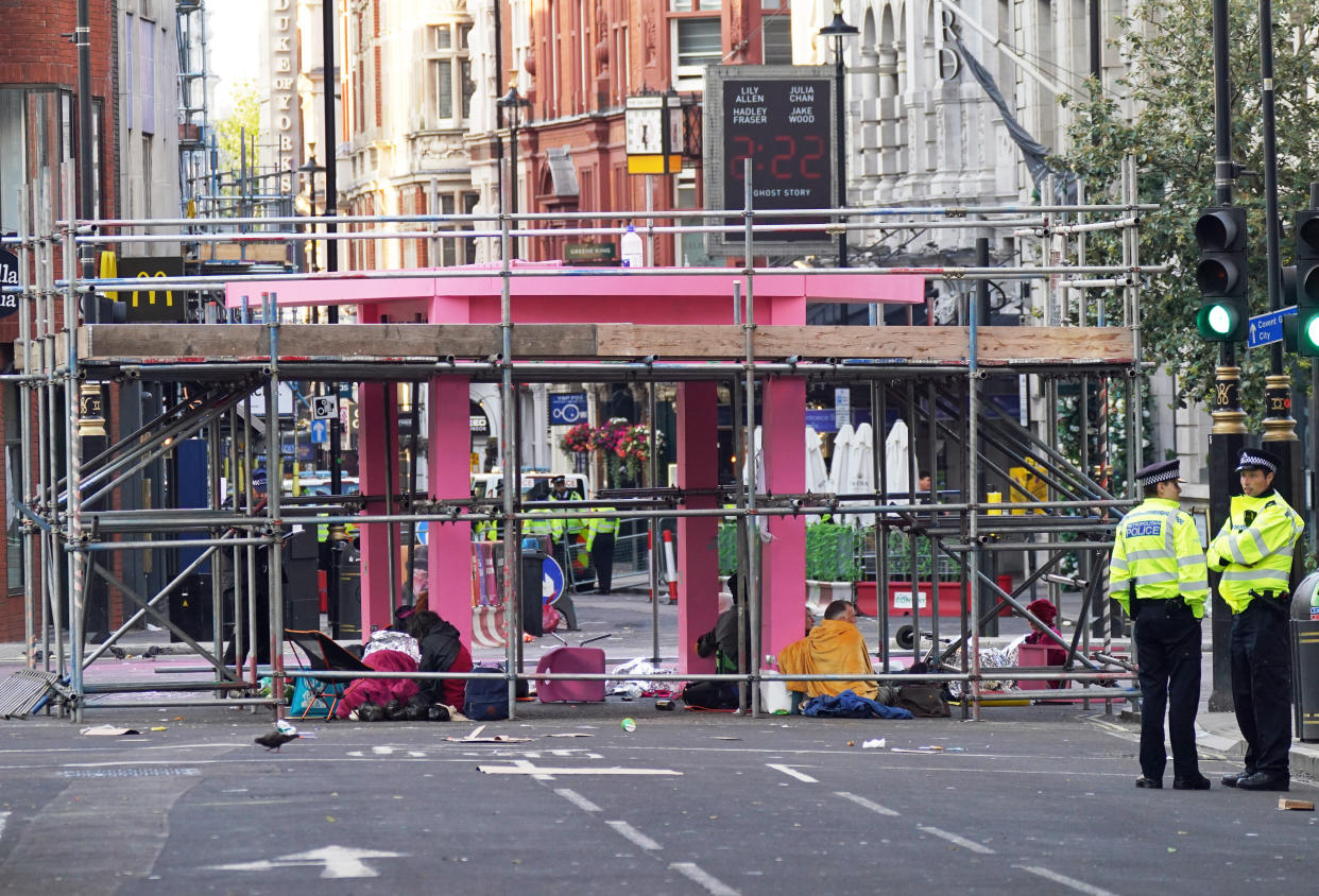 Police patrol in central London where environmental activists constructed Monday a large pink structure blocking the junction of Long Acre and Upper St Martin's Lane.