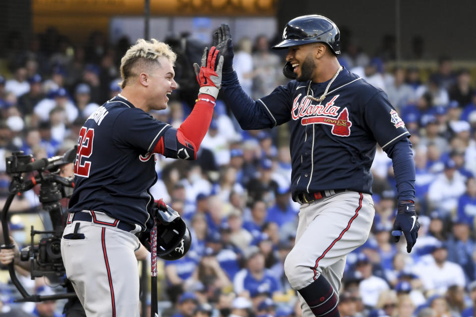 Braves outfielder Eddie Rosario, right, celebrates with Joc Pederson after smashing a home run against the Dodgers in NLCS Game 4.