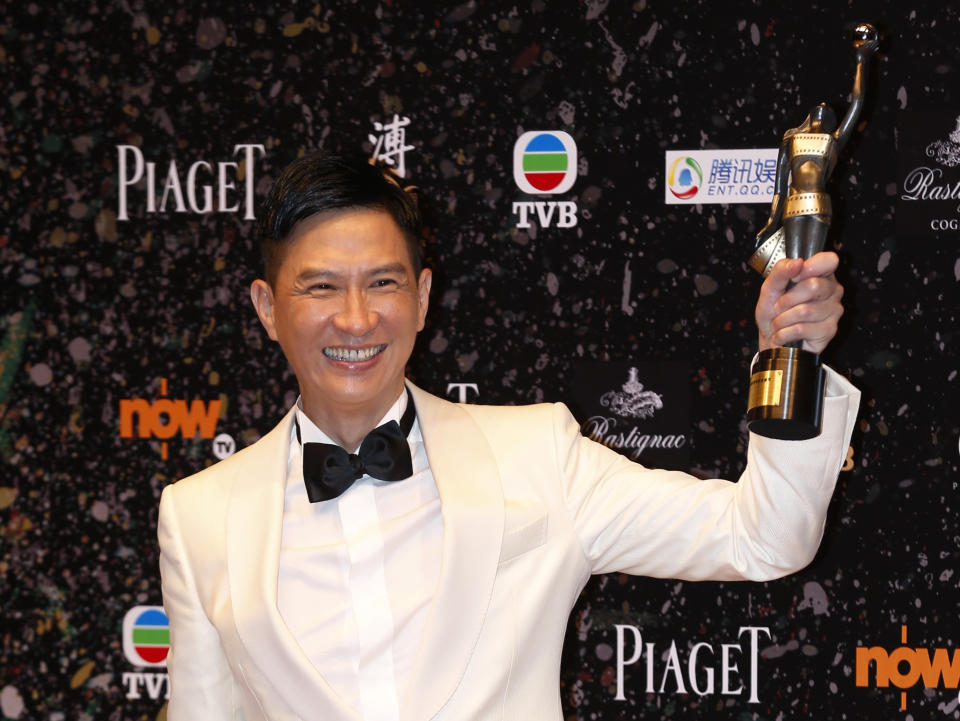 Hong Kong actor Nick Cheung Ka-fai poses after winning the Best Actor award for his movie “Unbeatable” at the 33rd Hong Kong Film Awards in Hong Kong Sunday, April 13, 2014. (AP Photo/Kin Cheung)