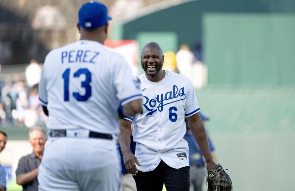 Former Kansas City Royals center fielder Lorenzo Cain laughs after throwing the ceremonial first pitch to former teammate Salvador Perez during a retirement ceremony at Kauffman Stadium on Saturday, May 6, 2023, in Kansas City. Cain signed a ceremonial one-day contract to retire as a Royal.