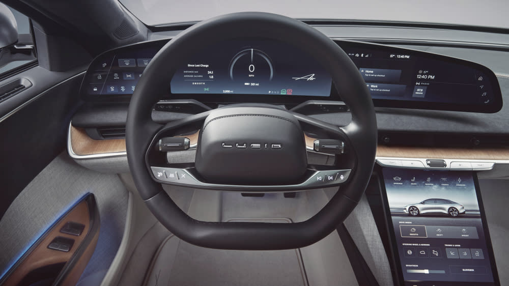 A wide, digital display stretches out in front of the driver, while a dual-screen setup in the central stack includes a smaller screen above and a larger tablet near the center console. - Credit: Lucid Group, Inc.