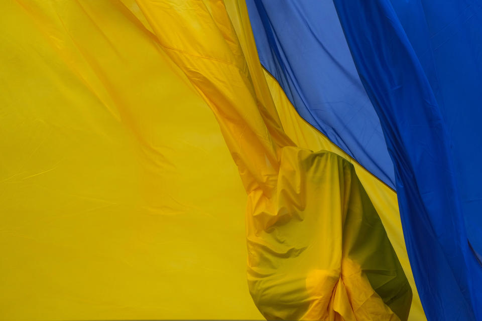 Ukrainian honor guard soldiers take part in a national flag-raising ceremony during a commemorative event on the anniversary of the liberation of the territories from the Russian troops in Bucha, on the outskirts of Kyiv, Ukraine, Friday, March 31, 2023. (AP Photo/Efrem Lukatsky)