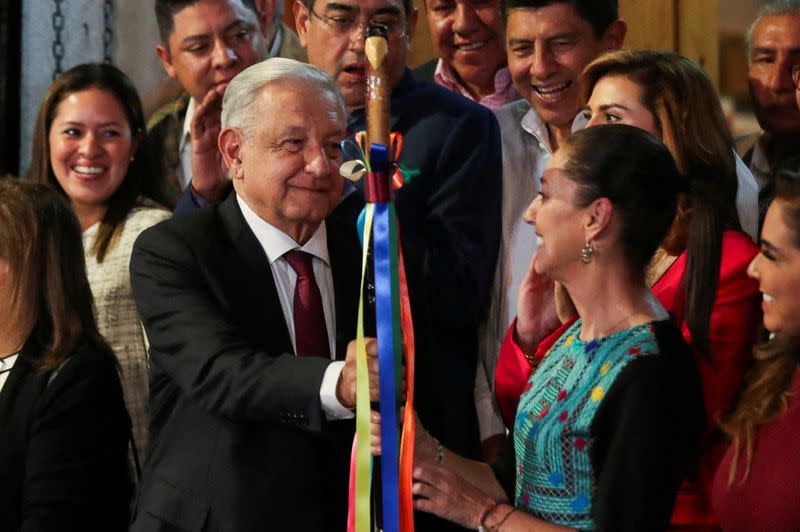 FILE PHOTO: Mexico's President Andres Manuel Lopez Obrador hands over the "baton of command" to Claudia Sheinbaum