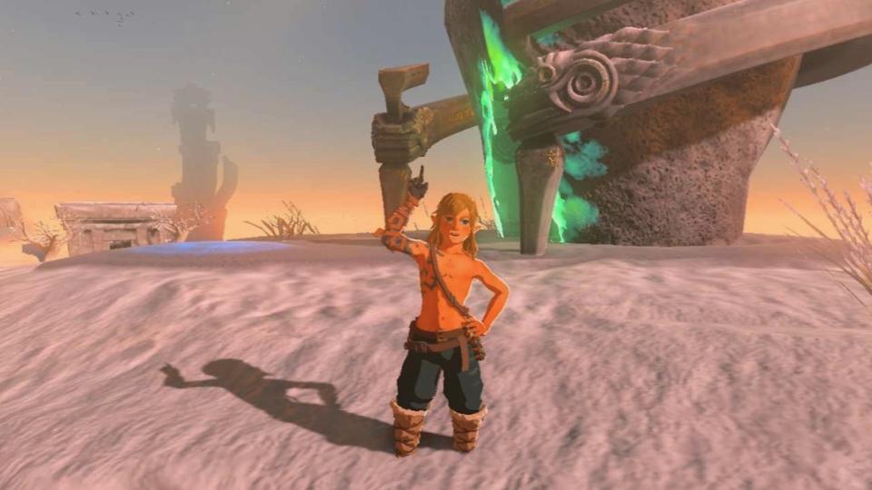 Link stands wearing the Archaic Greaves and Snowquill armor. His feet are half buried in snow