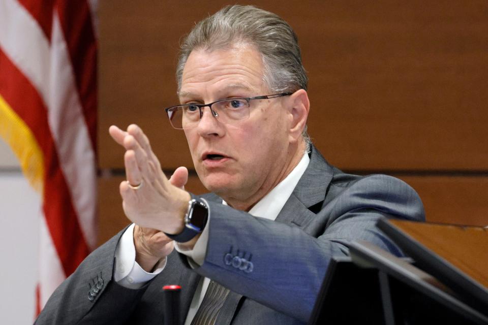 Clinical neuropsychologist Dr. Robert L Denney describes the motor skills that would be necessary to sight a weapon while moving (as Marjory Stoneman Douglas High School shooter Nikolas Cruz would have done in a video shown to jurors) during the penalty phase of Cruz’s trial at the Broward County Courthouse in Fort Lauderdale on Tuesday, Oct. 4, 2022. Cruz previously plead guilty to all 17 counts of premeditated murder and 17 counts of attempted murder in the 2018 shootings. (Amy Beth Bennett/South Florida Sun Sentinel via AP, Pool)