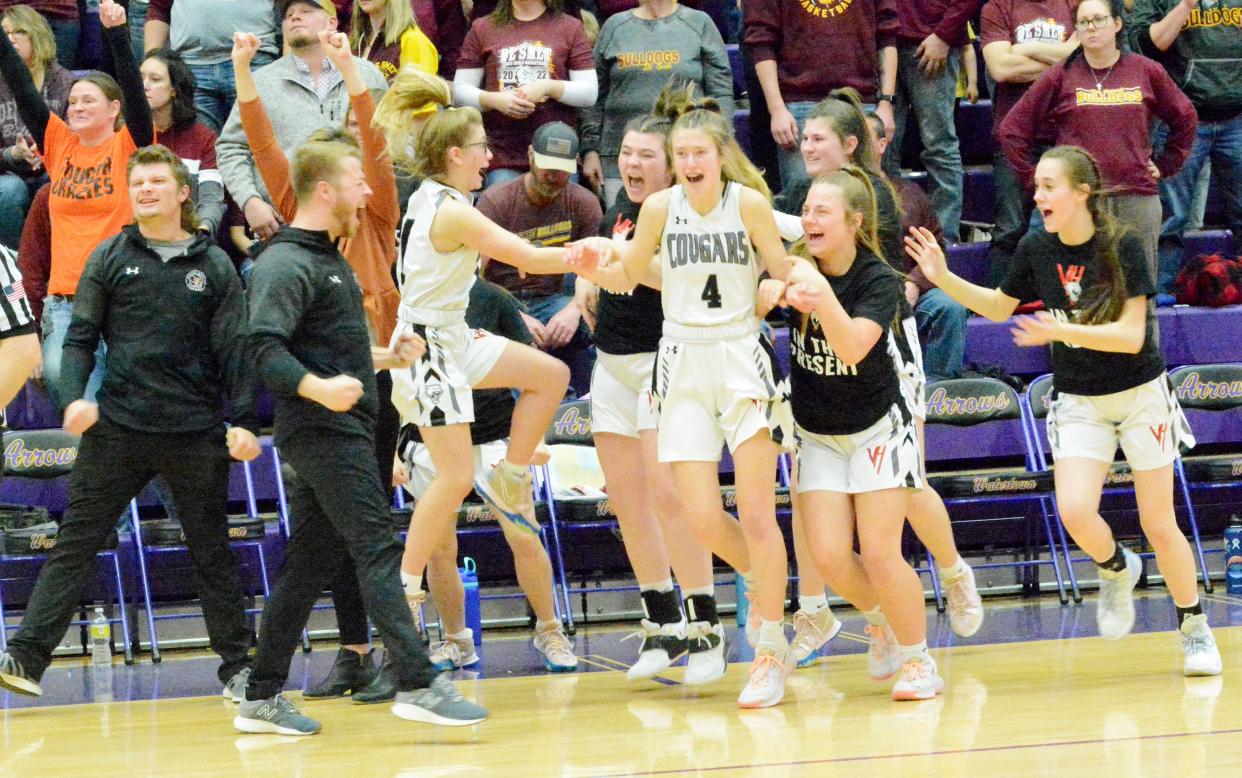 Viborg-Hurley players and coaches celebrate after beating De Smet 58-53 in the championship game of the state Class B girls basketball tournament Saturday night in the Watertown Civic Arena.