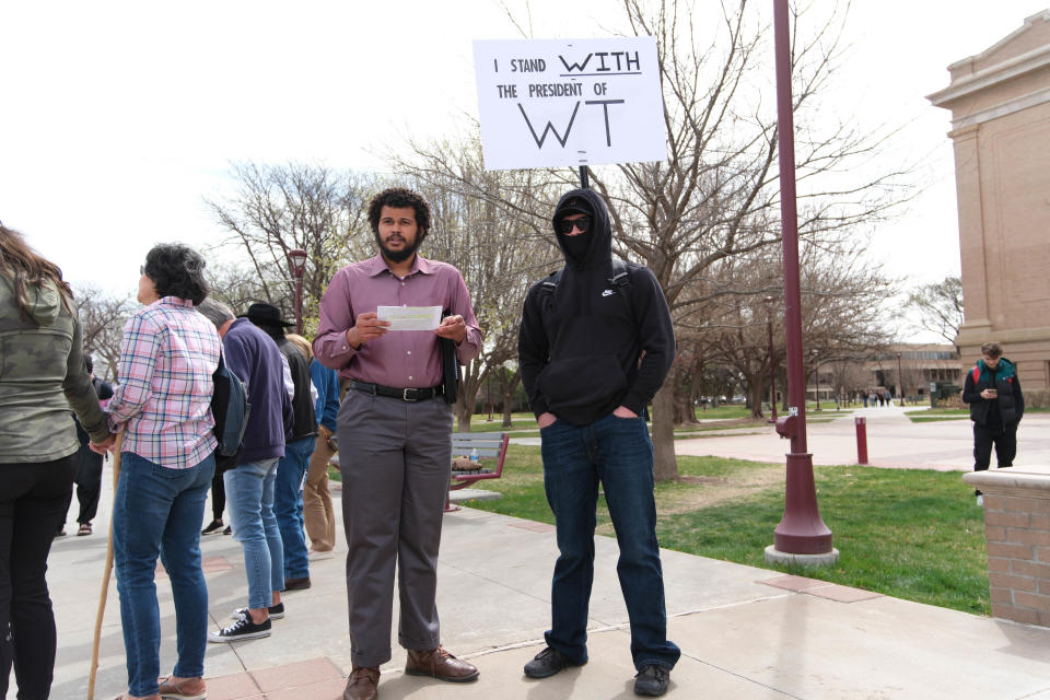 A counterprotester stands with a sign Thursday in support of WT President Walter Wendler and his letter canceling a drag show in campus in Canyon.