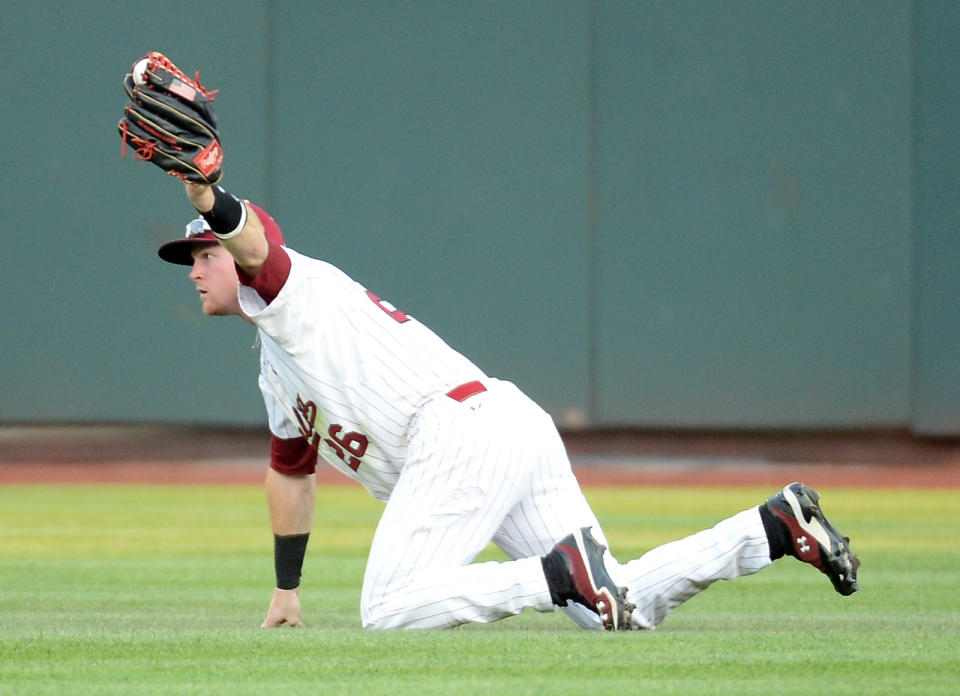 OMAHA, NE - JUNE 25: Adam Matthews #26 of the South Carolina Gamecocks makes a catch for an out of Alex Mejia #13 of the Arizona Wildcats in the fourth inning during game 2 of the College World Series at TD Ameritrade Field on June 25, 2012 in Omaha, Nebraska. (Photo by Harry How/Getty Images)