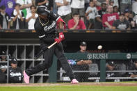 Chicago White Sox's Eloy Jimenez hits a two-run double during the eighth inning of the team's baseball game against the Houston Astros on Monday, Aug. 15, 2022, in Chicago. The White Sox won 4-2. (AP Photo/Charles Rex Arbogast)