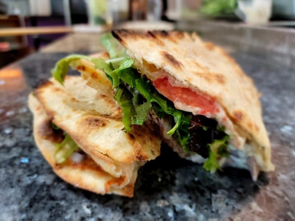 Buddy's Beef at Ossorio Bakery & Cafe in Cocoa Village features seasoned beef and melted cheese wrapped in a crisp flatbread.