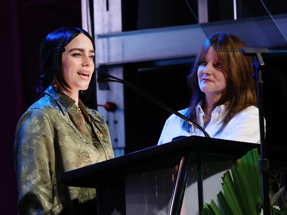 Billie Eilish and Maggie Baird speak onstage during the 32nd Annual EMA Awards Gala honoring Billie Eilish, Maggie Baird And Nikki Reed presented by Toyota on October 08, 2022 in Los Angeles, California