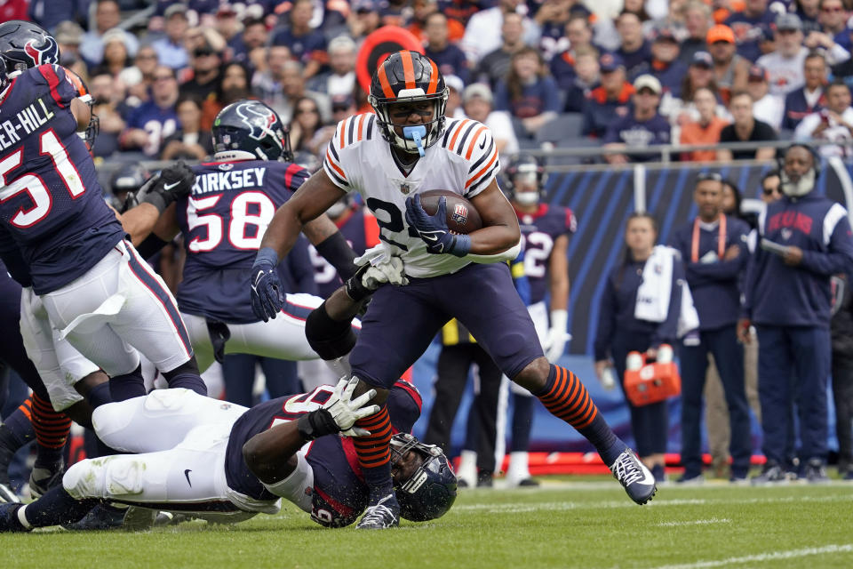 Chicago Bears running back Khalil Herbert (24) breaks away from Houston Texans defensive end Rasheem Green as he rushes for a touchdown during the first half of an NFL football game Sunday, Sept. 25, 2022, in Chicago. (AP Photo/Nam Y. Huh)