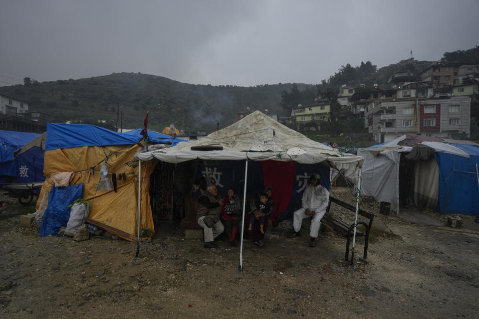 People with their homes were partially destroyed during the Feb. 2023 earthquake live in tents in Antakya, southern Turkey, Friday, Jan. 12, 2024. A year after the devastating 7.8 magnitude earthquake struck southern Turkey and northwestern Syria, a massive rebuilding effort is still trudging along. The quake caused widespread destruction and the loss of over 59,000 lives. (AP Photo/Khalil Hamra)