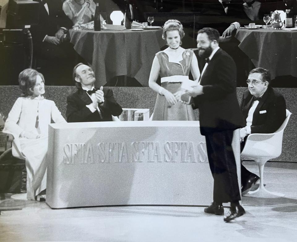 Collecting an award from Princess Anne for his 1971 film Alaska: The Great Land