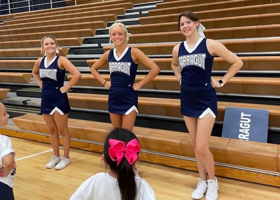 Farragut High School cheerleaders exercise their leadership skills teaching little ones cheers and dances at the cheerleading camp at the school Wednesday, June 15, 2022. From left, Mariah McDonald, Ella Macready, Carys Wygal.