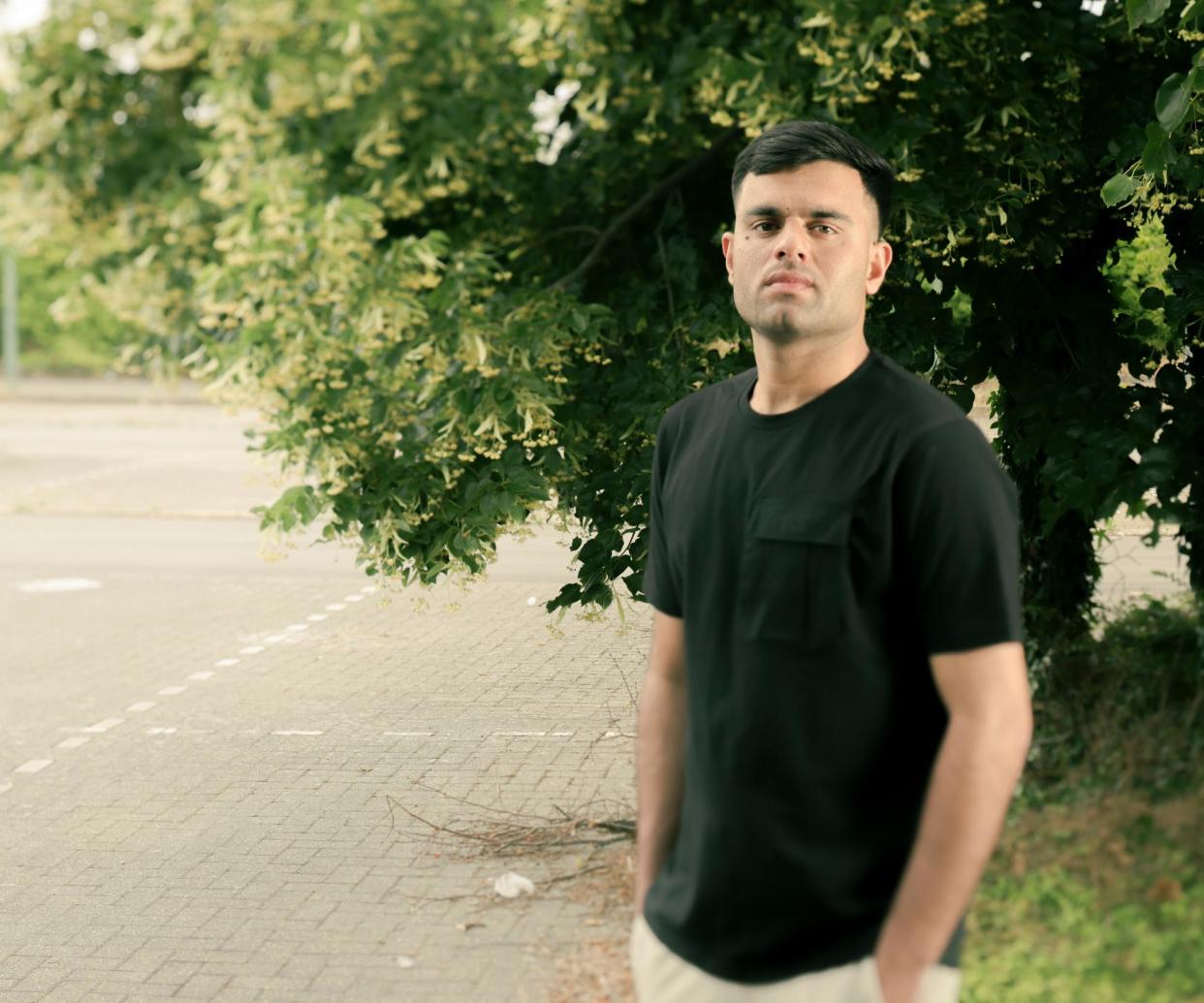 <span>Khalil Ullah in the car park in London where his brother Muhammad Ayaz’s body was found in 2001.</span><span>Photograph: Manuel Vazquez/The Guardian</span>