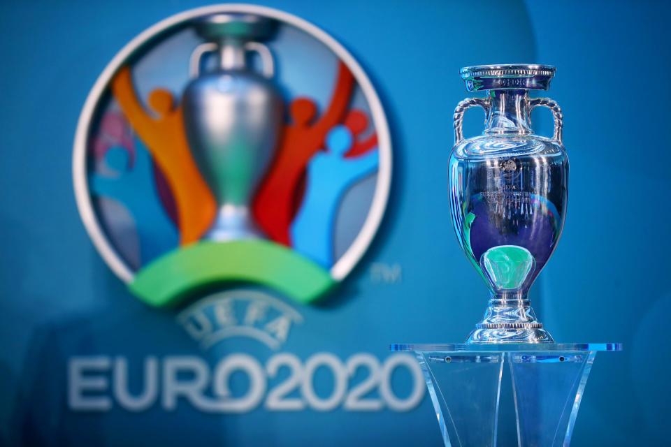 The European Championship trophy next to the logo for Euro 2020: Getty Images