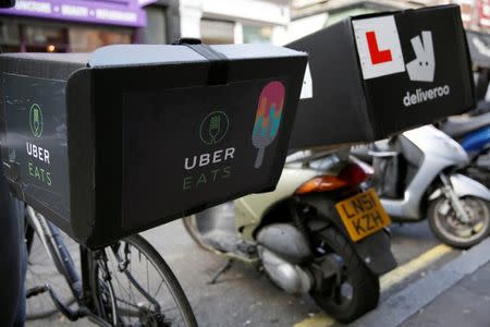 An UberEATS food delivery bike is seen parked next to a Deliveroo scooter in London, Britain September 7, 2016. REUTERS/Neil Hall