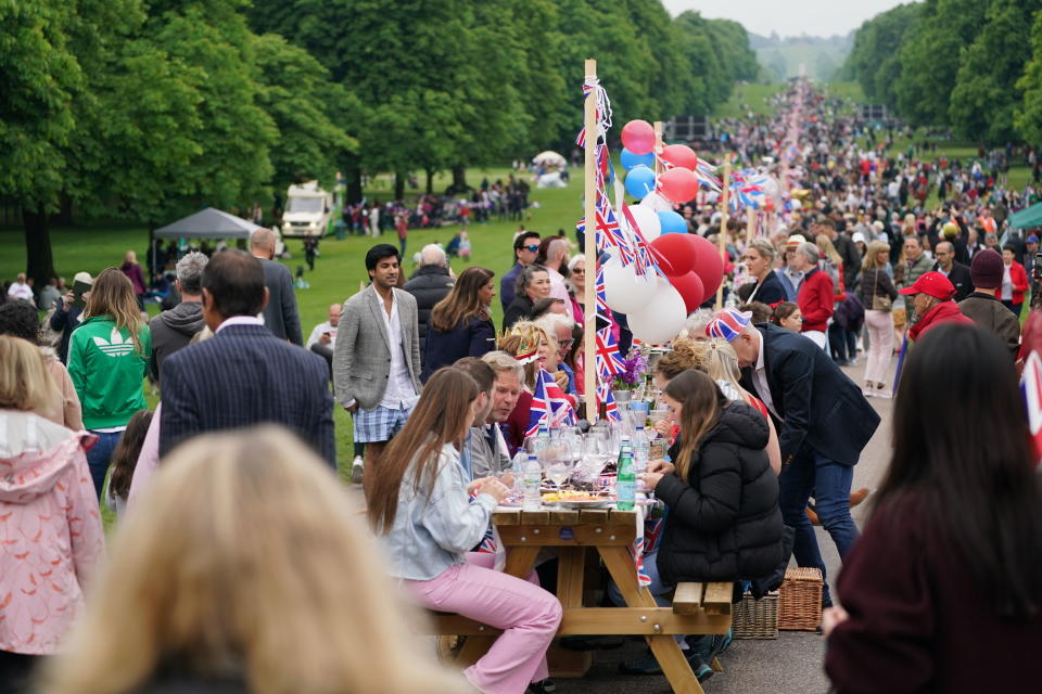 Members of the local community participate in the Big Jubilee Lunch at 'The Long Table' on The Long Walk outside Windsor Castle in Windsor, England, Sunday, June 5, 2022, on day four of the Platinum Jubilee celebrations. (Steve Parsons/PA via AP)