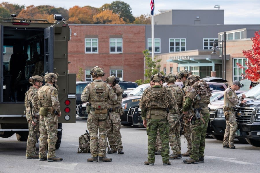 TOPSHOT – Law enforcement officers gather outside Lewiston High School, Maine on October 26, 2023. A massive manhunt was under way on October 26 for a gunman who a local official said killed at least 22 people and wounded dozens more in mass shootings in the US state of Maine, the deadliest such incident this year. (Photo by Joseph Prezioso / AFP) (Photo by JOSEPH PREZIOSO/AFP via Getty Images)