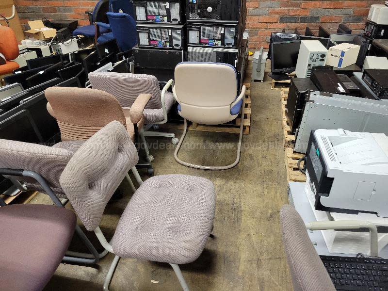 A photo of numerous old office chairs. 