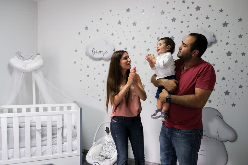 Emmanuelle Lteif Khnaisser, who was in labour at the moment of last year's Beirut port blast, plays with her son, baby George Khnaisser, at the family home in Jal el-Dib