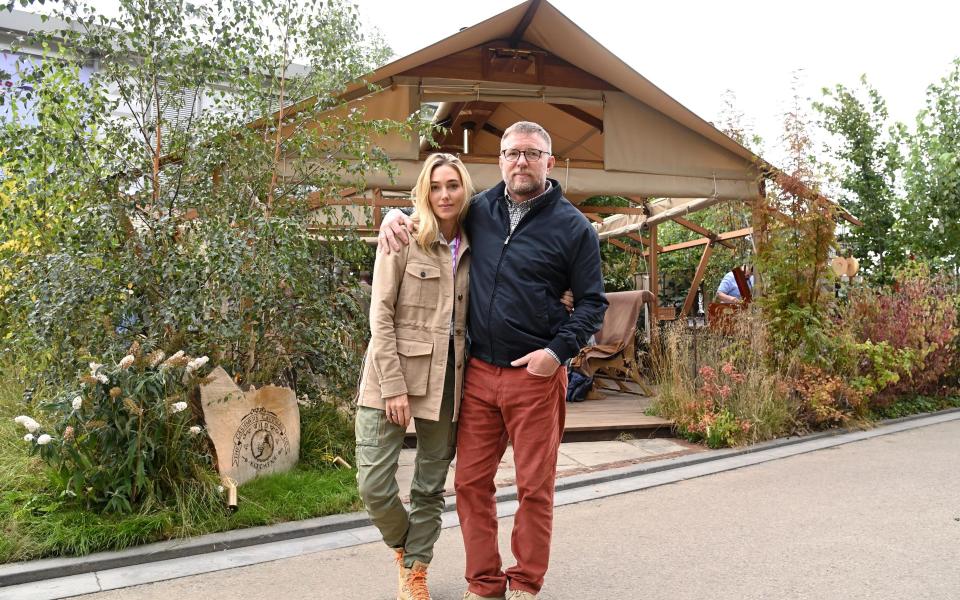 Guy Ritchie, with Jacqui Ainsley, in front of his stand and the tent that will apparently withstand 30mph winds - Karwai Tang