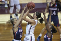Gonzaga's Jenn Wirth, center, shoots over Belmont's Conley Chinn (20) during the first half of a college basketball game in the first round of the women's NCAA tournament at the University Events Center in San Marcos, Texas, Monday, March 22, 2021. (AP Photo/Chuck Burton)