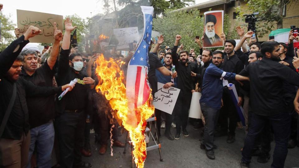 Iranian students burn a US flag during a demonstration denouncing the burning in Sweden of the Koran, Islam's holy book, in front of Swedish embassy in Tehran on July 21, 2023. Picture: AFP