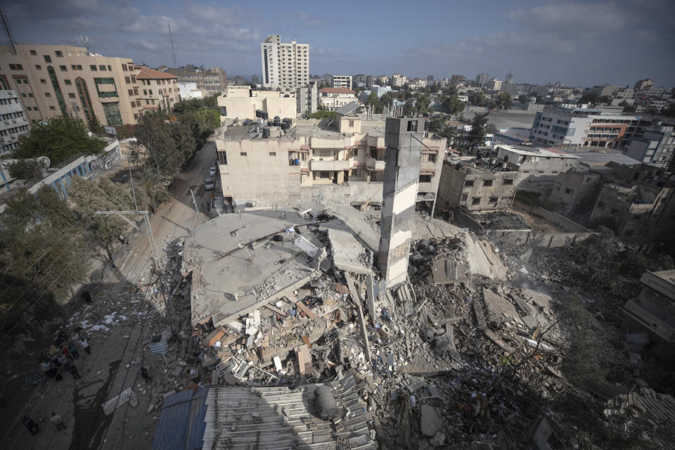 A top view shows the remains of a six-story building which was destroyed by an early morning Israeli airstrike, in Gaza City, Tuesday, May 18, 2021. Israel carried out a wave of airstrikes on what it said were militant targets in Gaza, leveling a six-story building in downtown Gaza City, and Palestinian militants fired dozens of rockets into Israel early Tuesday, the latest in the fourth war between the two sides, now in its second week. (AP Photo/Khalil Hamra)