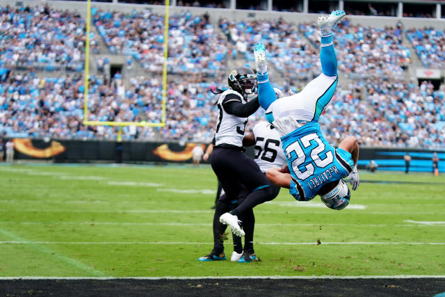 Christian McCaffrey of the Carolina Panthers jumps over Tre