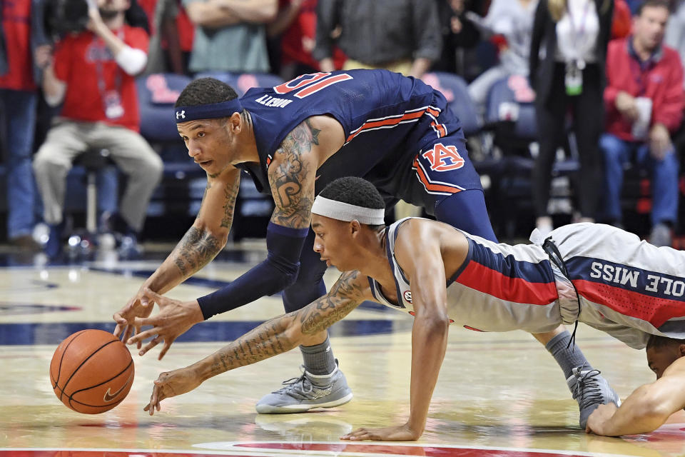 Auburn guard Samir Doughty (10) and Mississippi guard Austin Crowley dive for the ball during the second half of an NCAA college basketball game in Oxford, Miss., Tuesday, Jan. 28, 2020. Auburn won 83-82. (AP Photo/Thomas Graning)