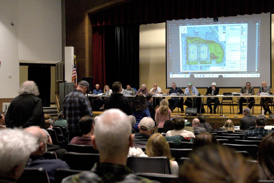 Residents line up to question the developer during an Upper Freehold planning board meeting on Tuesday, February 27, 2024 at Stone Bridge Middle School in Upper Freehold, New Jersey.