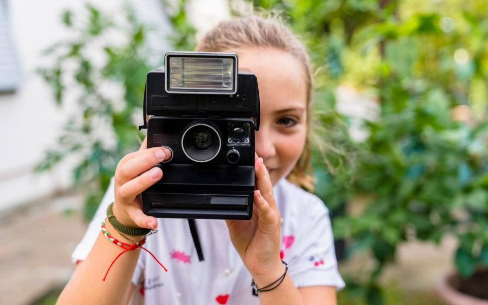 Sales of older technology such as Polaroid cameras have risen in recent months - Getty