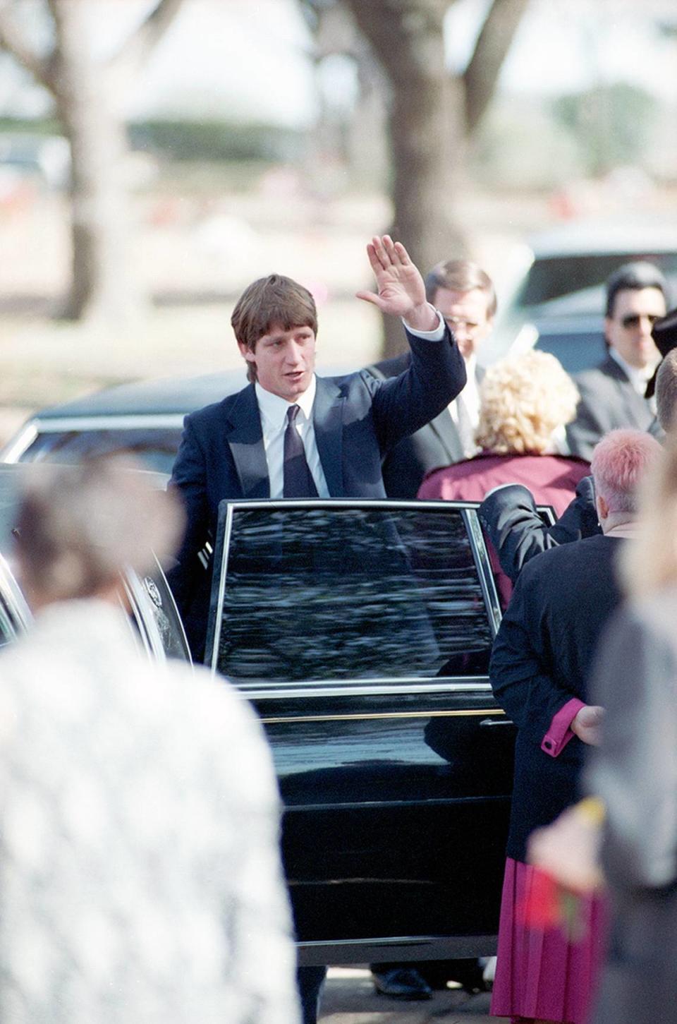 February 22, 1993: Wrestler Kerry Von Erich’s funeral held at First Baptist Church in Dallas. His brother, Kevin Von Erich, waves as he leaves the graveside ceremony at Grove Hill Cemetery in Dallas.